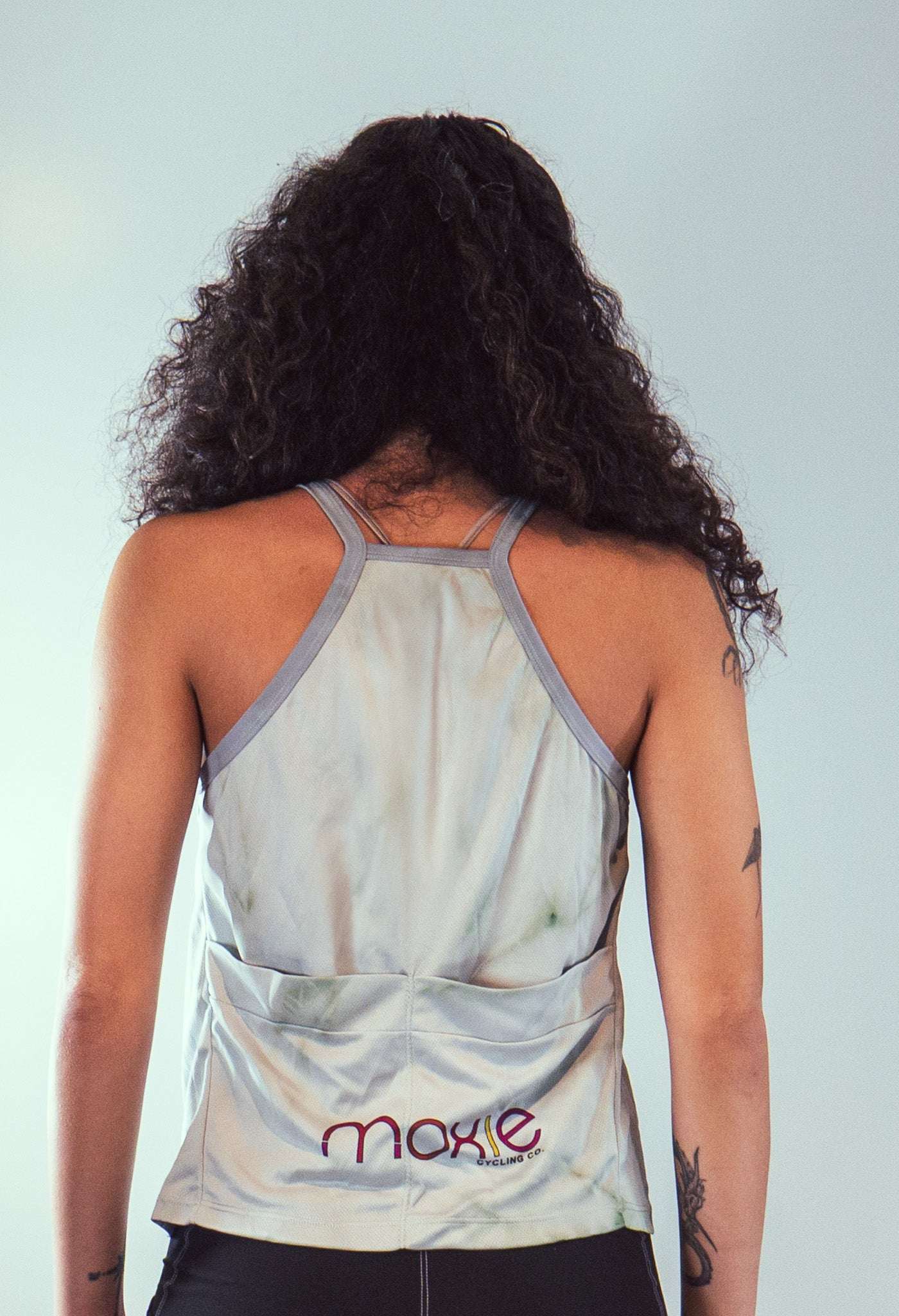 Women's sleeveless tie dye bike top with back pocket and strappy design in soft performance fabric