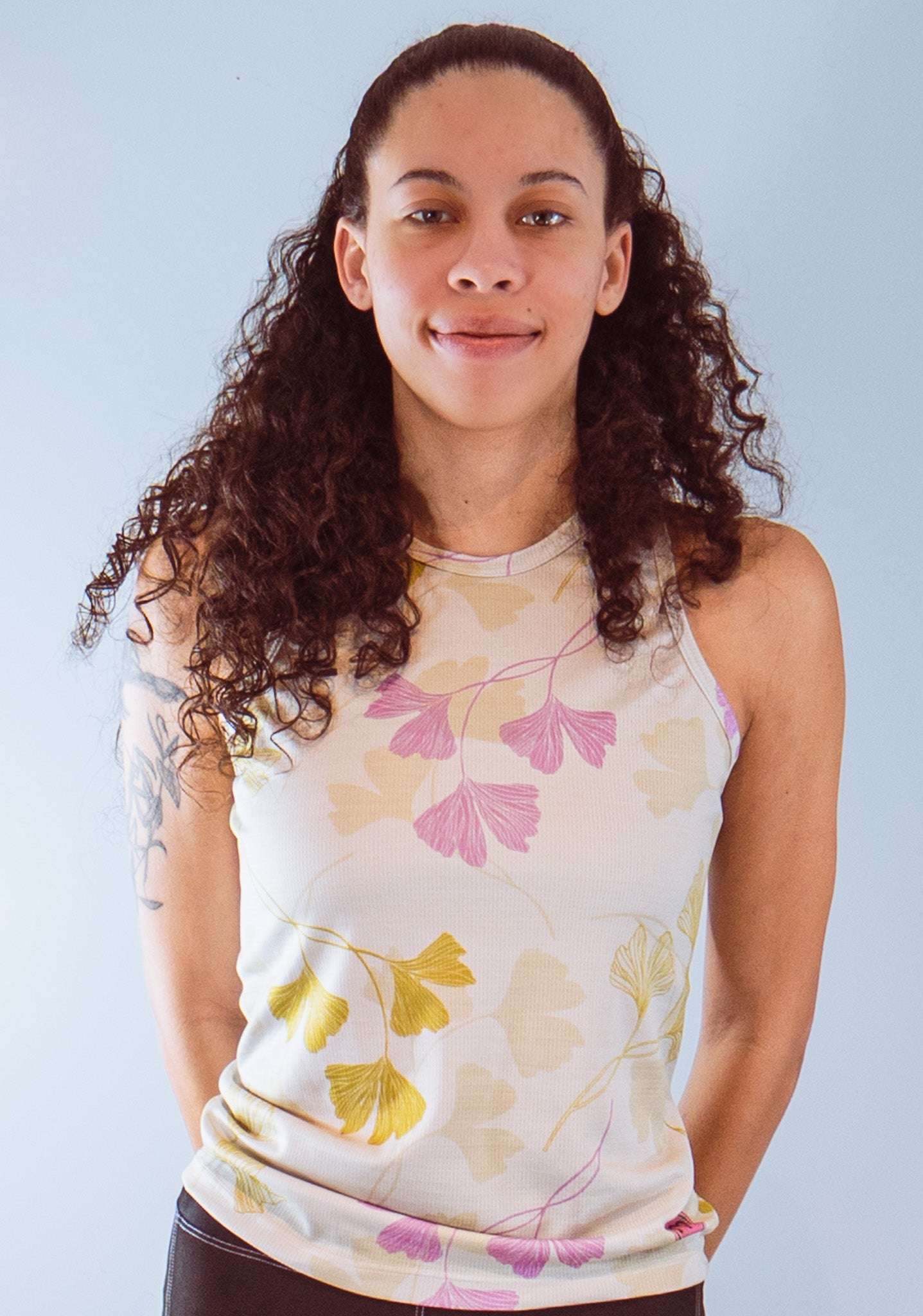 Women's sleeveless bike jersey with floral pattern, active mesh fabric.