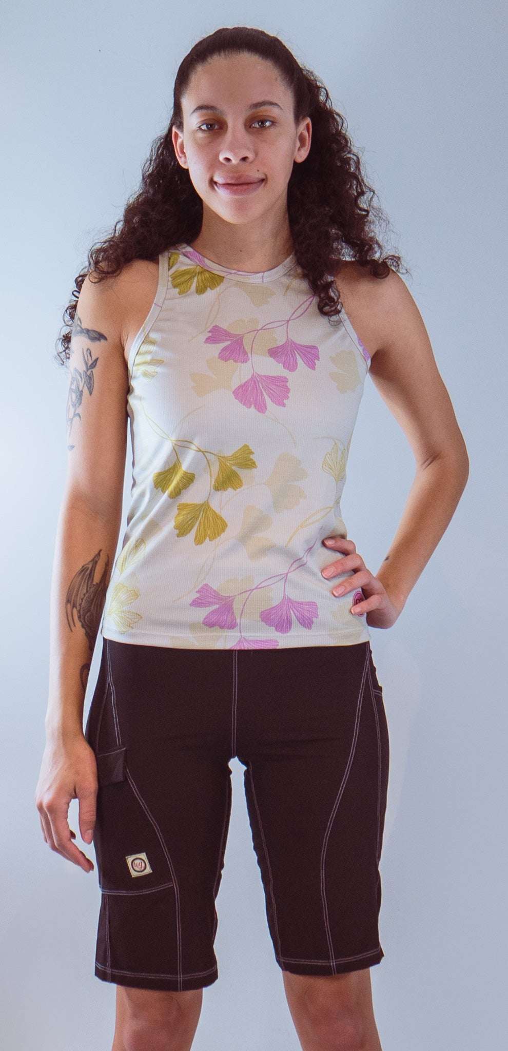 Women's sleeveless bike jersey with floral pattern, breathable mesh fabric, and back pocket.