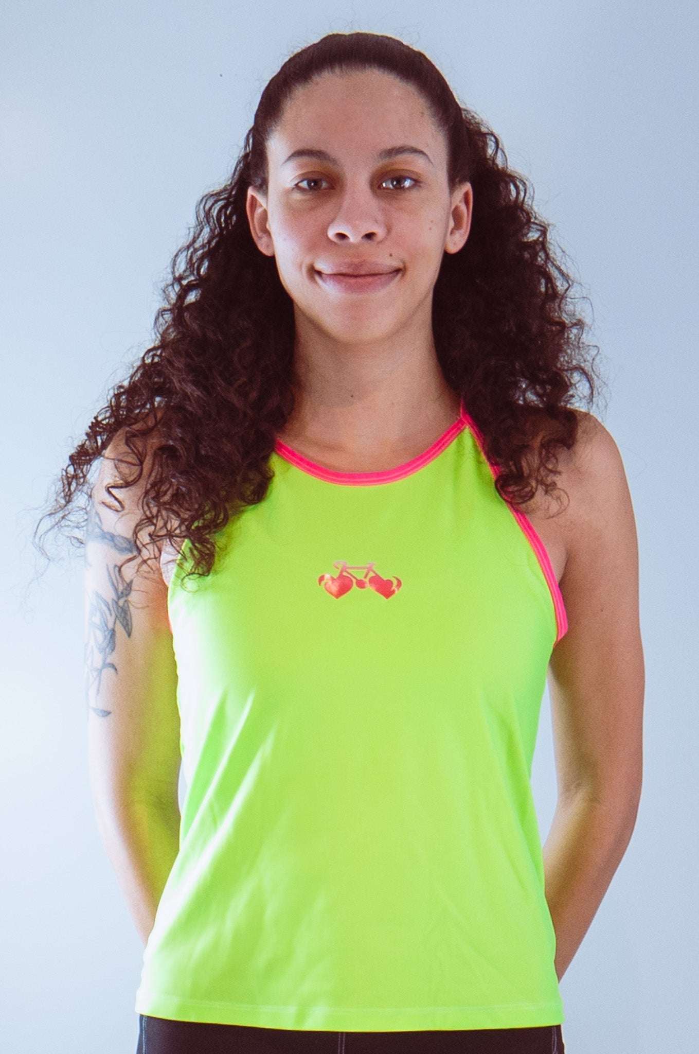 Women's sleeveless bike jersey high vis with bike graphic and back pocket.