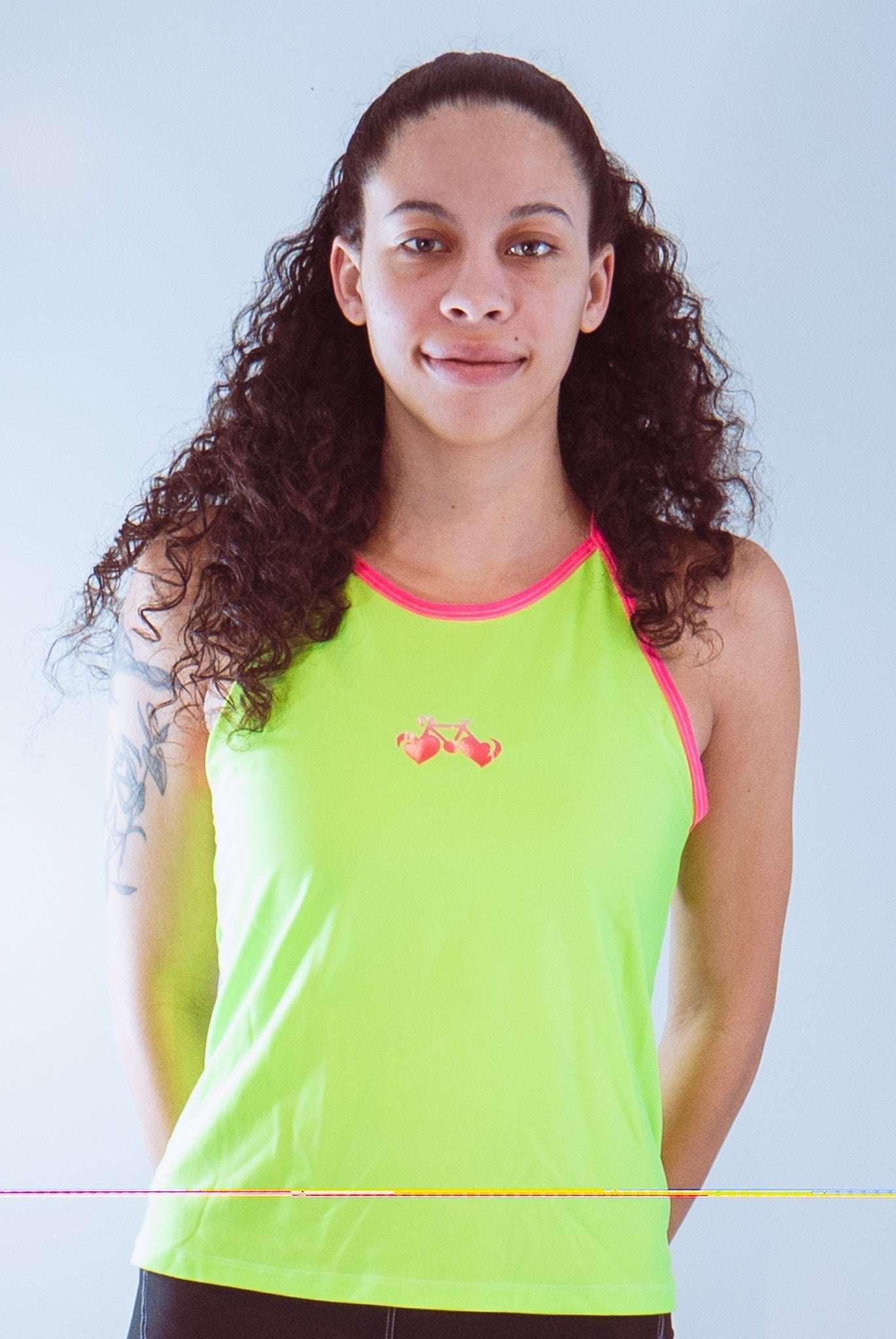 Women's sleeveless cycling jersey in neon green with pink trim and graphic, ideal for visibility and comfort.