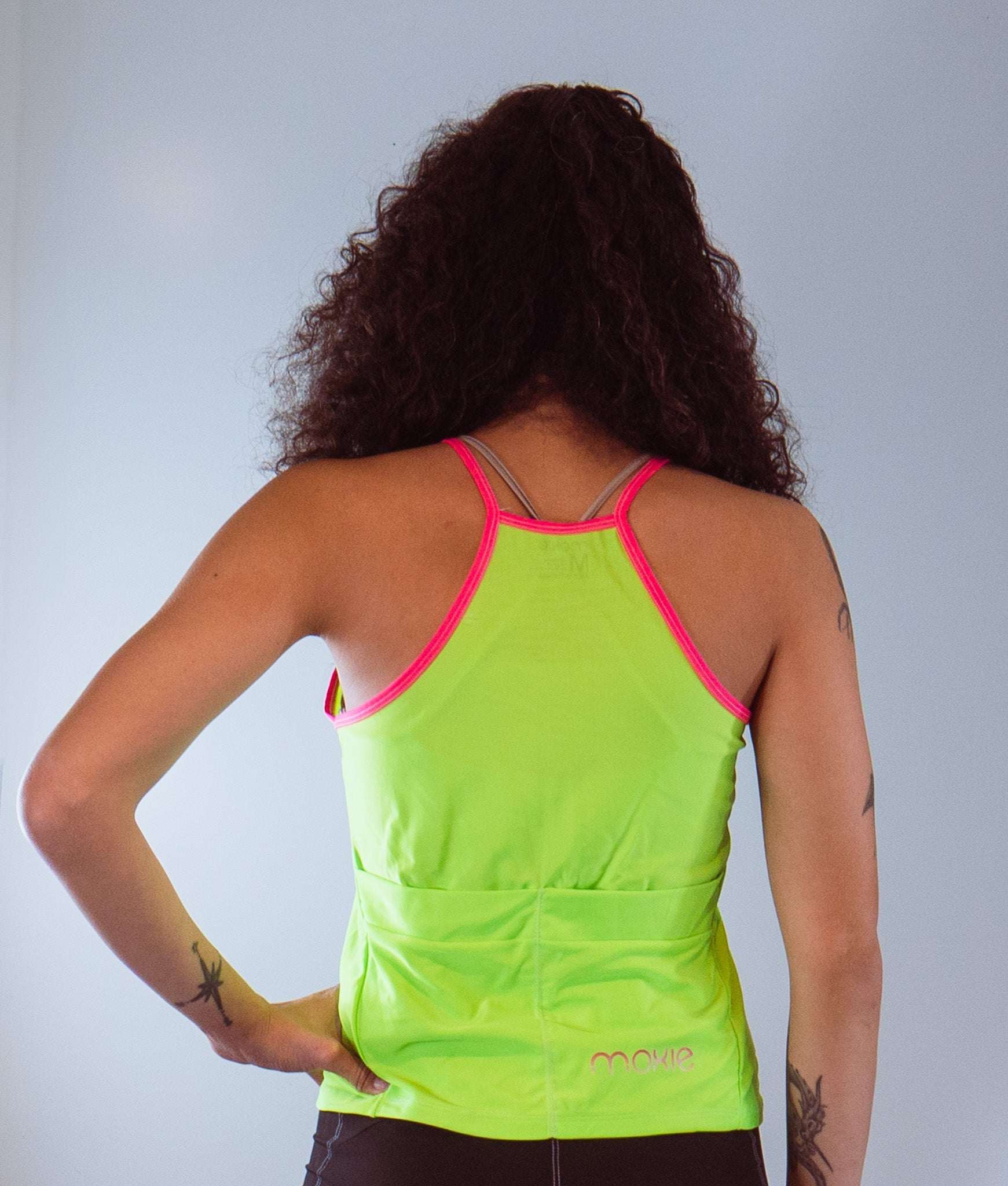 Women's sleeveless high vis cycling jersey with back pocket and vibrant trim.