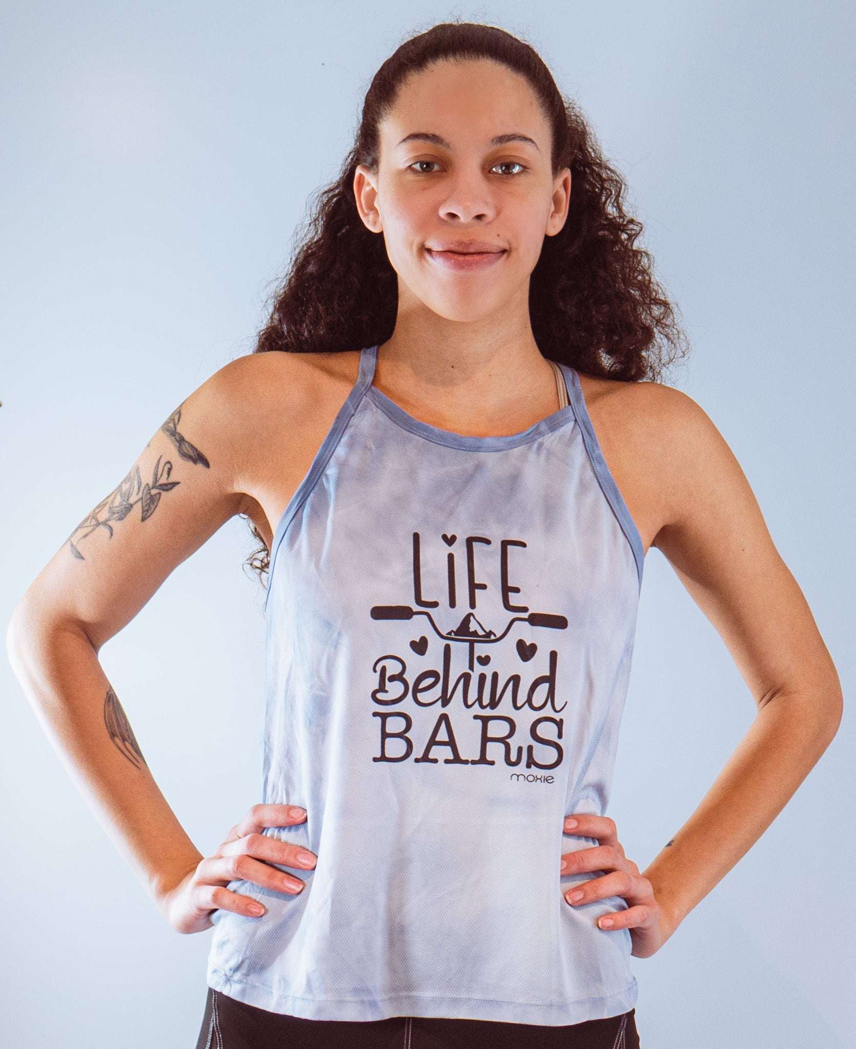 Women's sleeveless tie dye bike top with Life Behind Bars graphic and strappy design