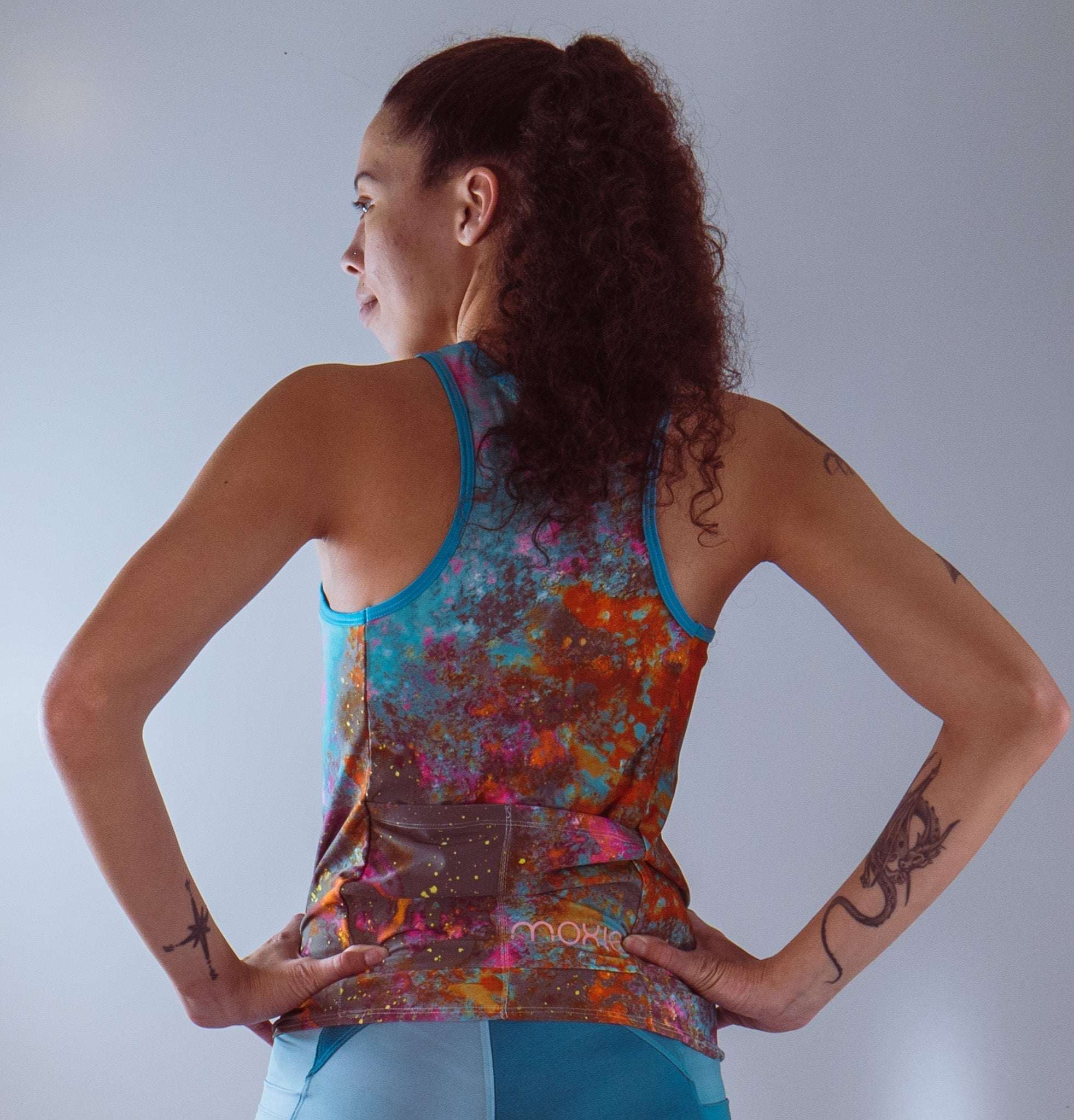Sleeveless women’s bike jersey with vibrant wild fire pattern, featuring a breathable mesh fabric and back pocket.