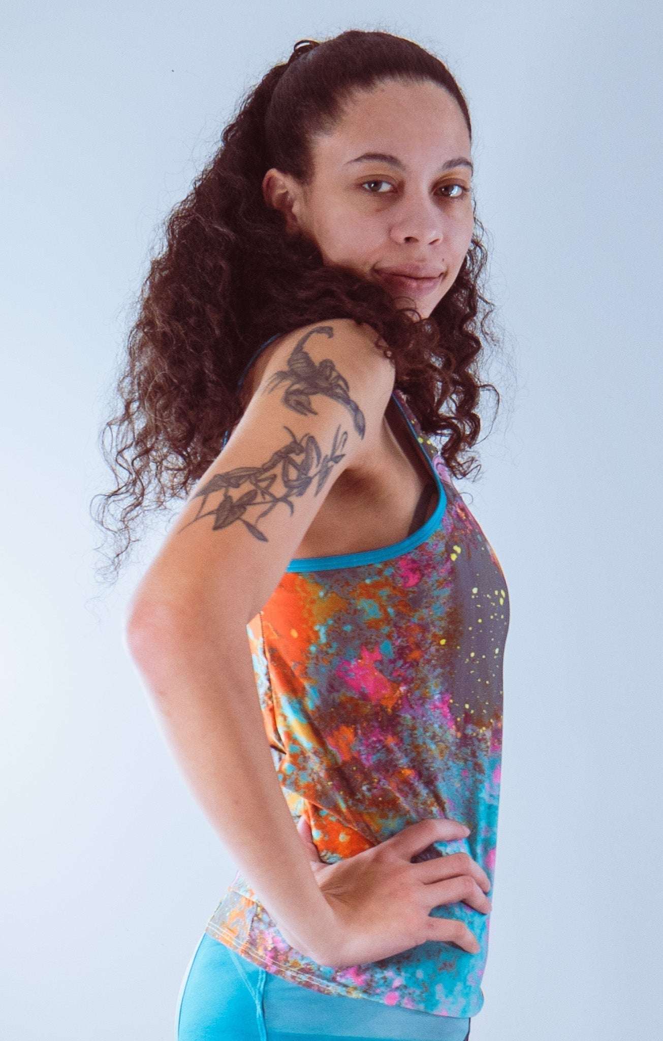 Women's sleeveless bike jersey in black and blue, breathable mesh fabric, side view.