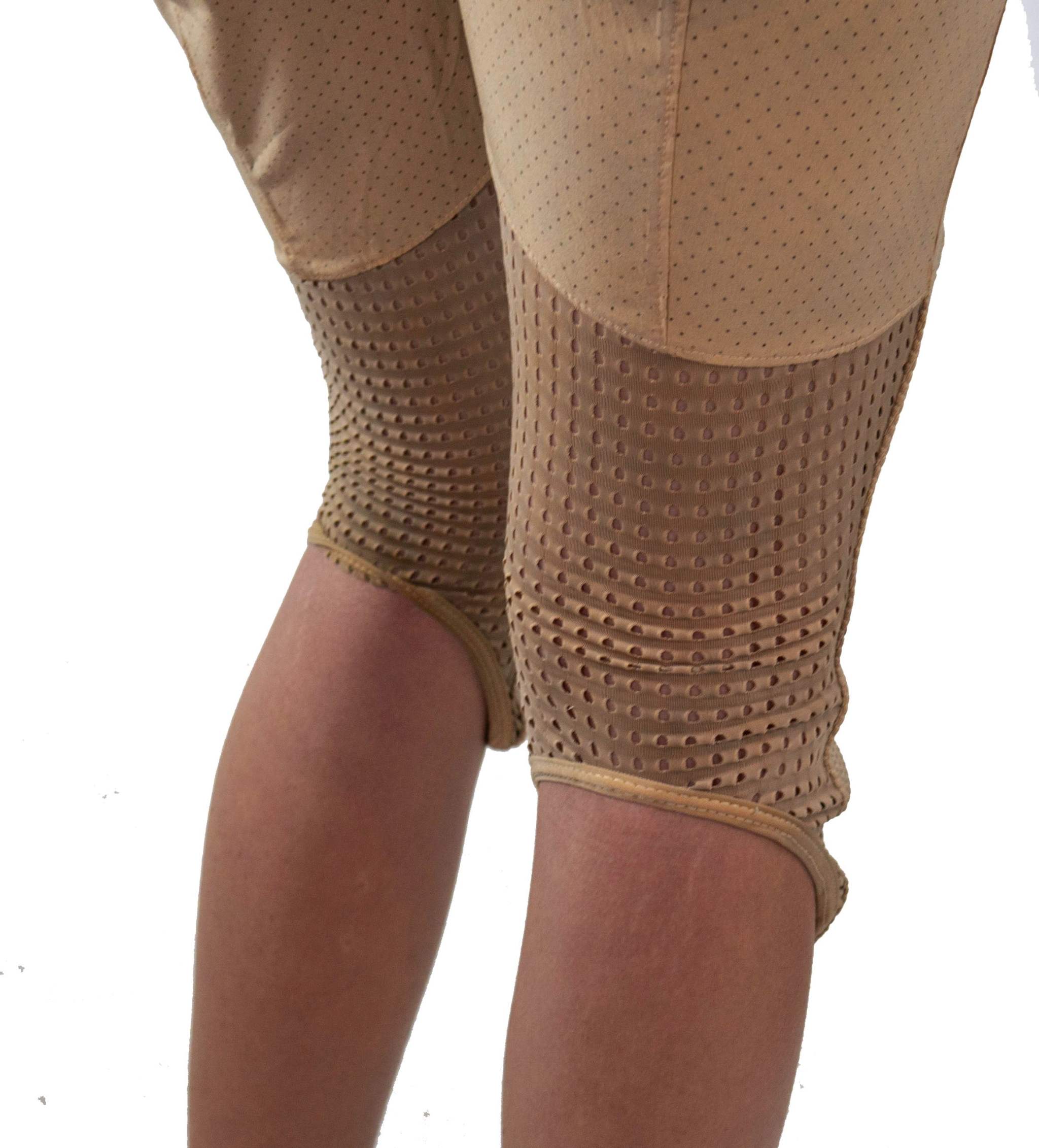 Close-up of beige women's mountain bike pants with breathable perforated fabric and integrated removable G-Form knee pads