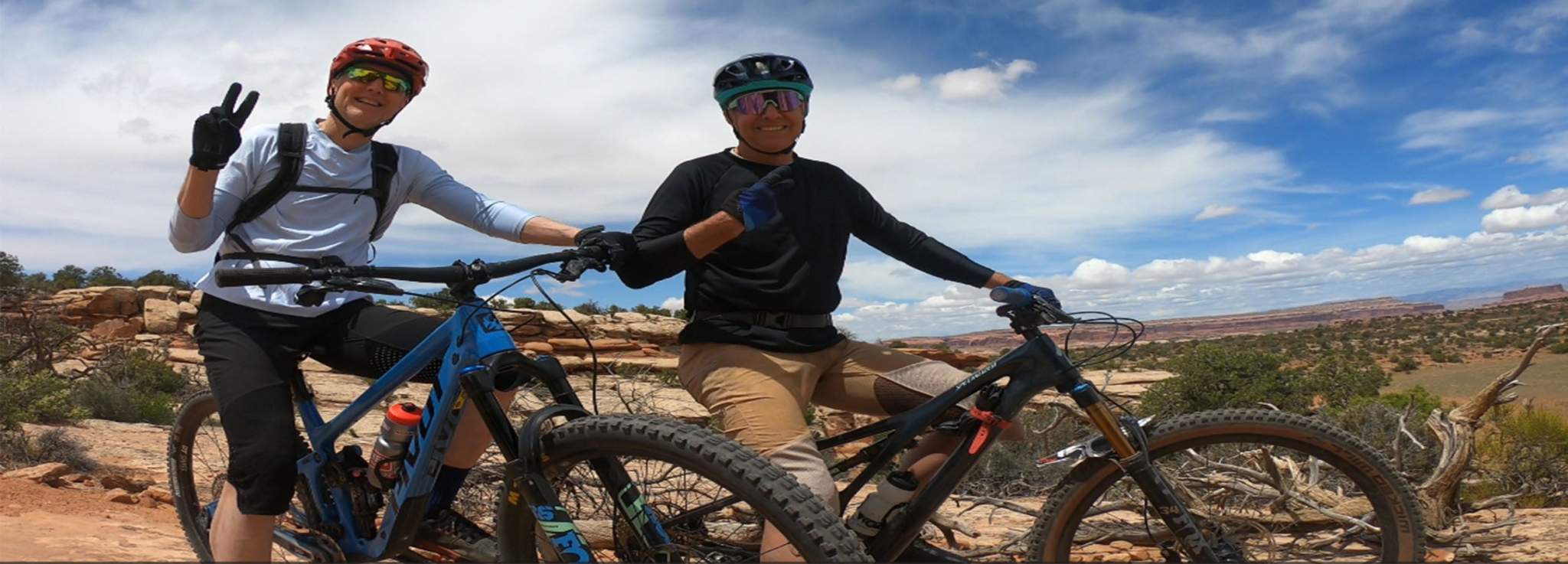 Pair of mountain bikers wearing Men's G-Form Mountain Bike Jersey with removable elbow pads on a trail.