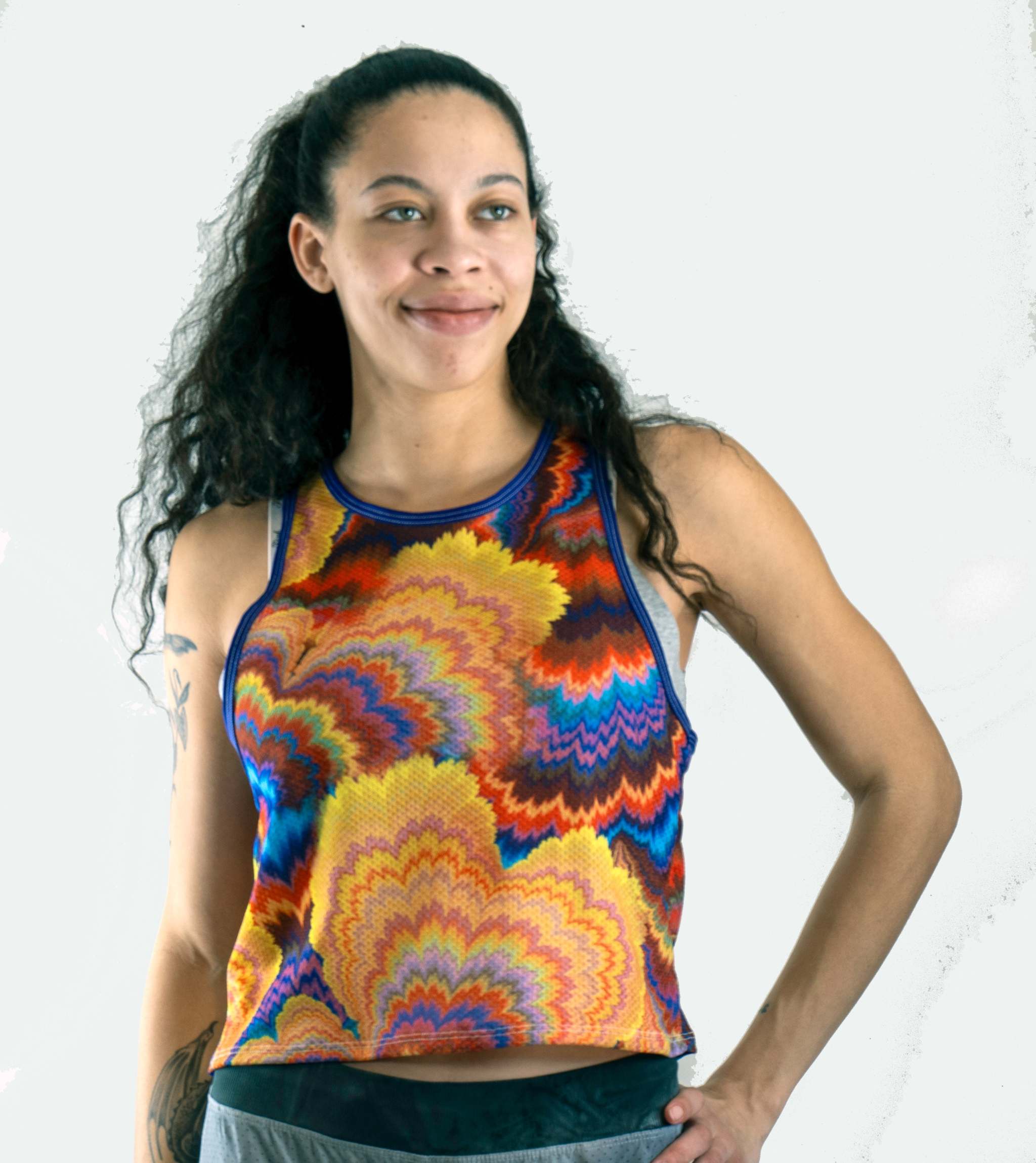 Woman wearing waffle-knit cropped tank mountain bike jersey riding on trail
