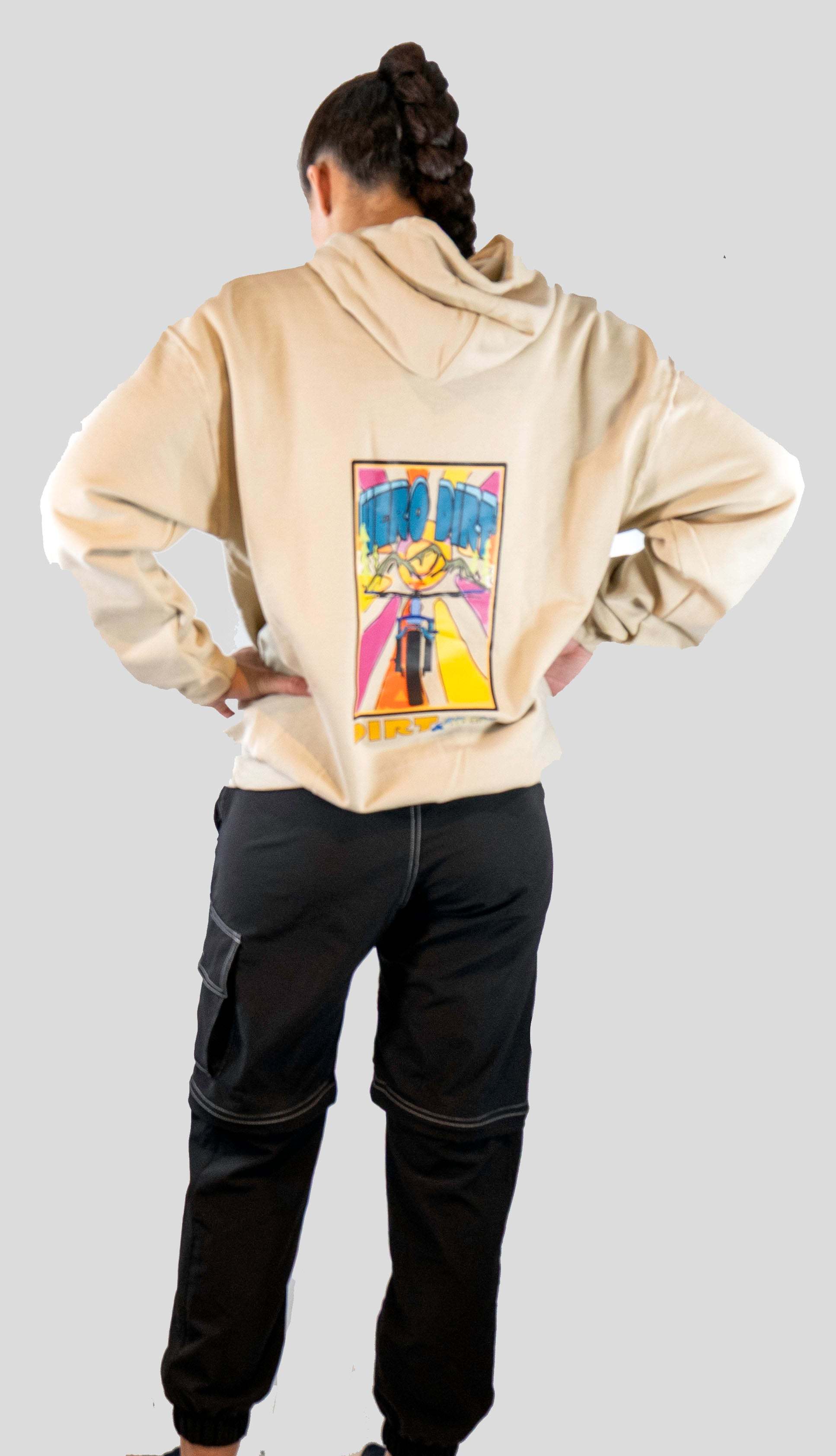 Person wearing a beige hoodie with a colorful graphic on the back against a plain background