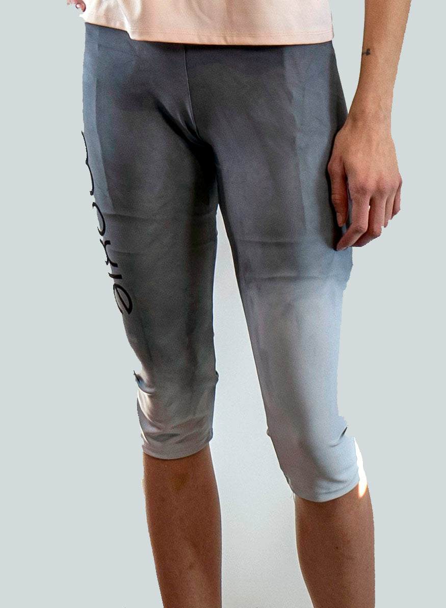 Person wearing gray athletic shorts with a gradient effect on a plain background