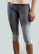 Person wearing gray athletic shorts with a gradient effect on a plain background
