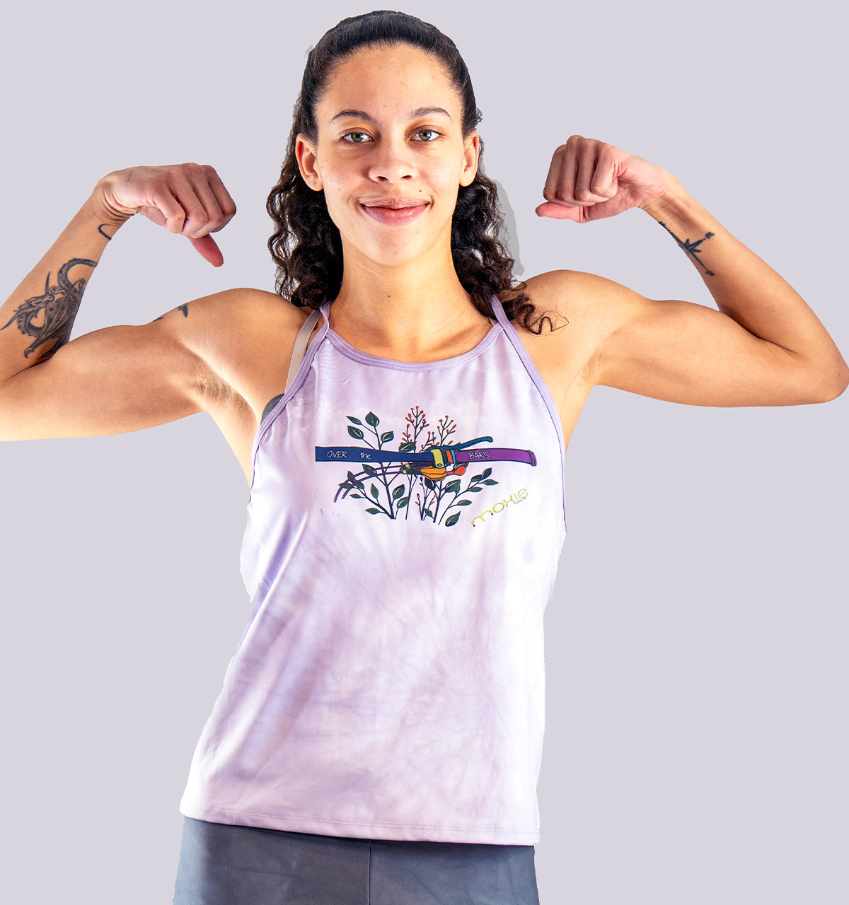 woman flexing her muscles while wearing a Moxie Cycling sleeveless jersey