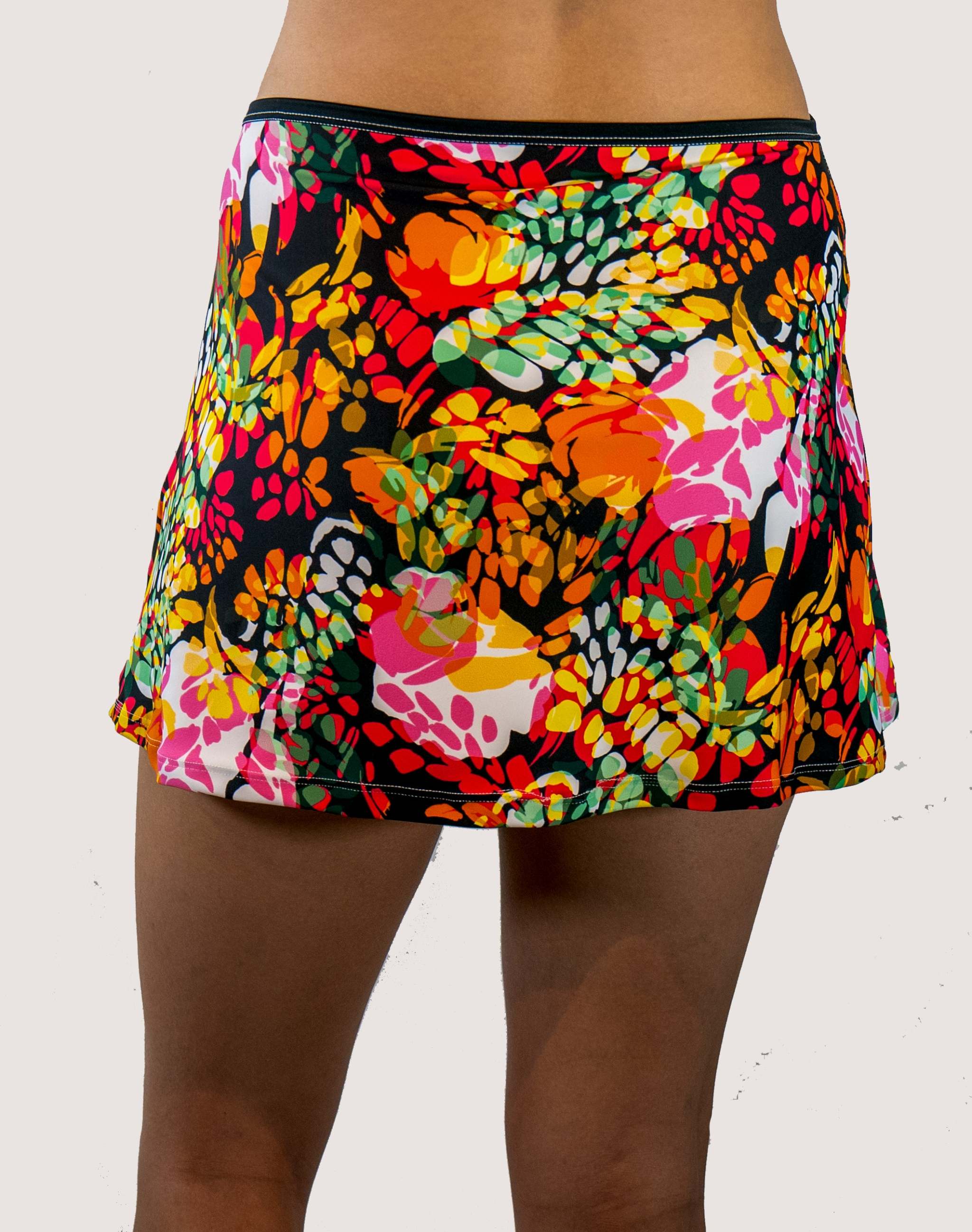 Colorful floral skirt worn by a person on a white background