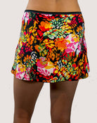 Colorful floral skirt worn by a person on a white background