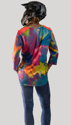 Colorful mountain bike jersey with looser fit and moisture-wicking fabric.