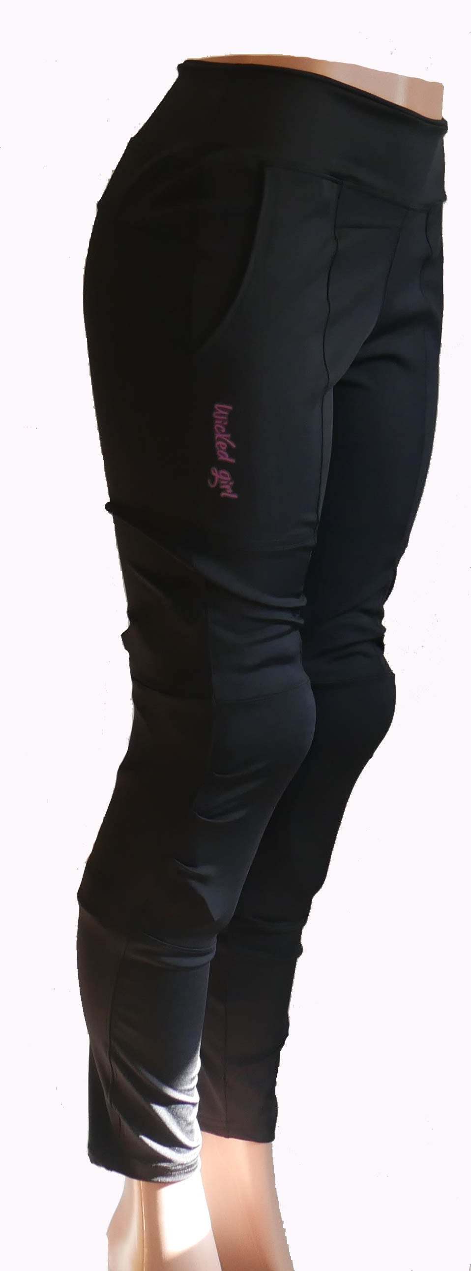 Women's bike pants in black with large front pockets and a side cell pocket, designed for comfort and movement.